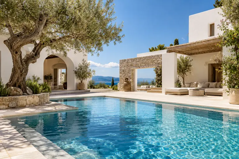 Concept imagery of a white villa with an azure pool and olive trees